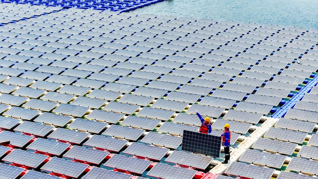 Floating solar panels providing renewable energy. Aerial view floating on solar cells and